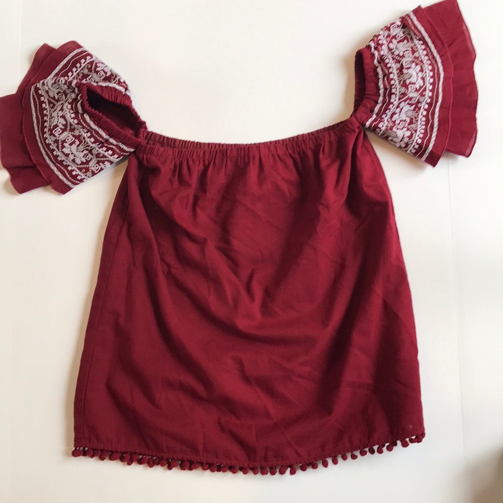 Maroon off the shoulder embroidered blouse.
